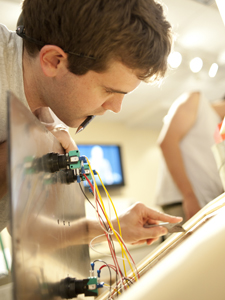 A student works on the circuitry for a stompbox