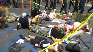 First responders conduct triage manuevers during disaster drill.