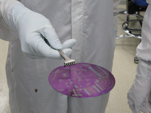 A researcger in the Nano3 lab loads a sample into a relative ion etcher. Nano3 provides essential nanofabrication capabilities for research on electronic and optoelectronic materials and devices, as well as biomedical and biochemical devices, heterogenous integrated devices and circuits, and sensor technology.