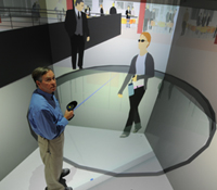 Tom DeFanti in computer model of Calit2 HQs inside the StarCAVE VR room.