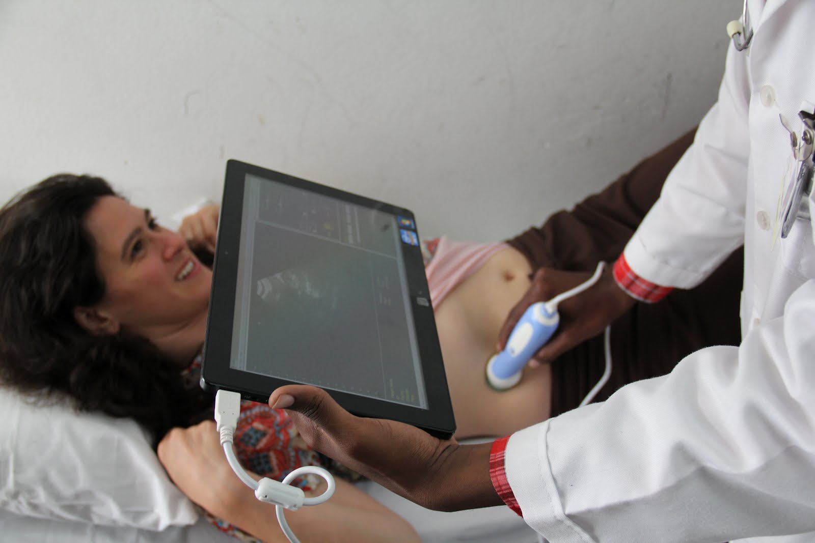 A doctor in Mozambique uses a tablet-based ultrasound developed by the DH Lab to analyze a patient. 