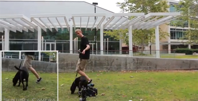 Calit2 researcher and canine friend testing camera trap outside UC San Diego's Atkinson Hall.