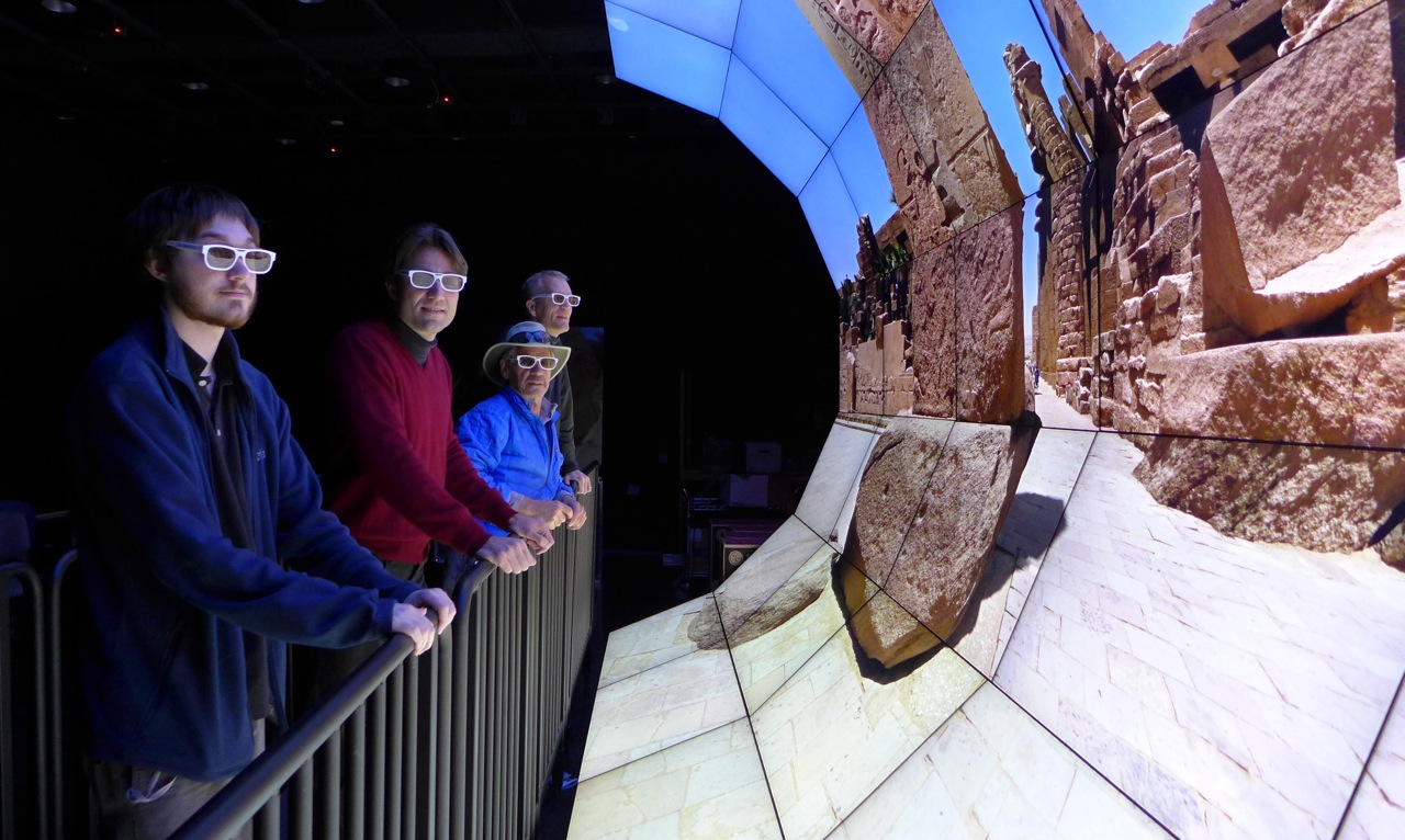 QI Researchers examining images from the Exodus exhibition on the WAVE