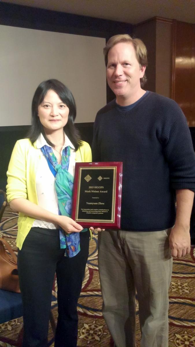 YY Zhou (left) poses with her award and computer scientist Stefan Savage, who won the same award back in 2013.