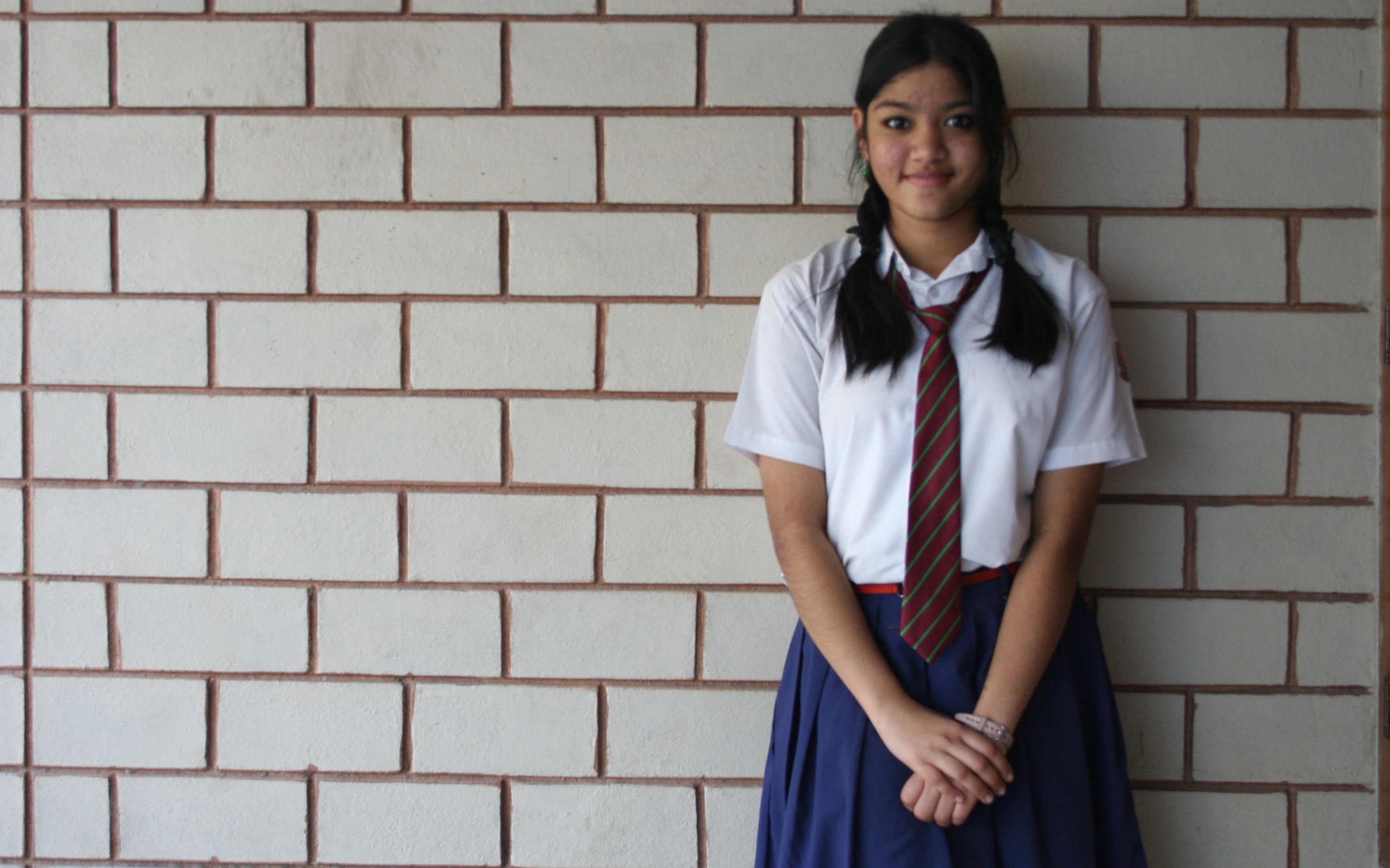 Schoolgirl standing and smiling