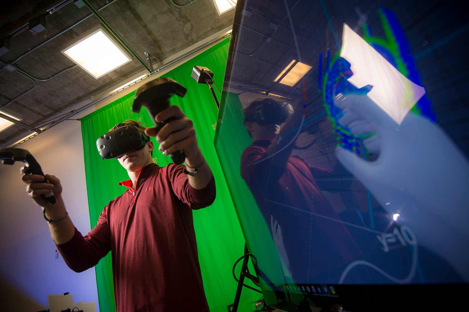 Steven McCloskey, co-founder of a new virtual reality startup, manipulates objects in an immersive environment.