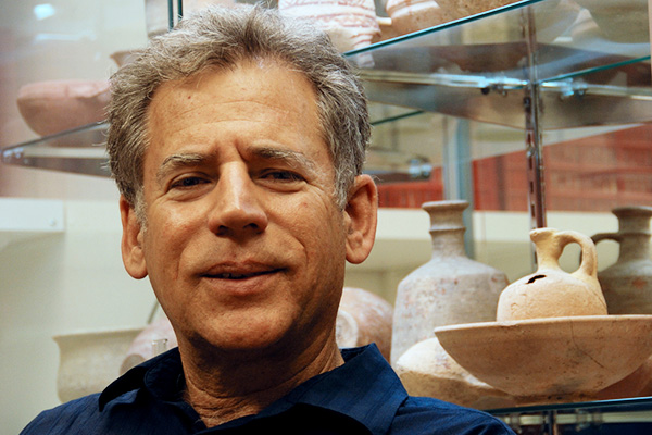 CCAS director Tom Levy in his lab with pottery artifacts in background.