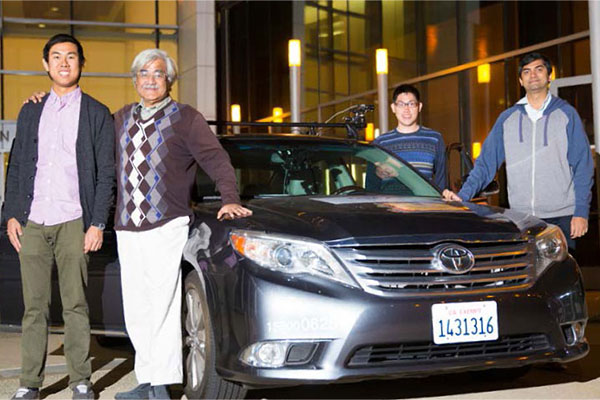 ECE Prof. Mohan Trivedi (second from left) with grad students and Toyota test vehicle.