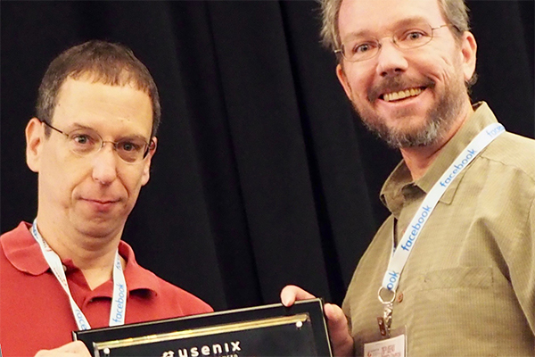 QI academic participant Geoffrey Voelker (right) accepts USENIX Security Test of Time Award for grou