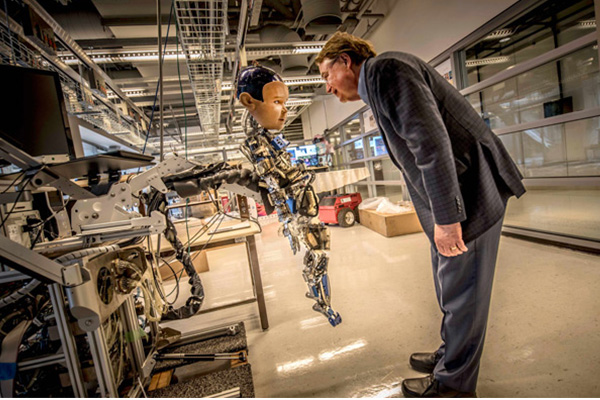 Larry Smarr with Diego-San, one of the robots in the Robot Zoo at Calit2