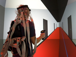 Ed Kezeli, a recent Computer Science and Engineering alumnus of UCSD, serves as a test subject in the "way-finding" study. Here, Kezeli is navigating through a 3-D rendering of a corridor in Calit2's Atkinson Hall, designed to be totally ambiguous and provide few orientation cues.